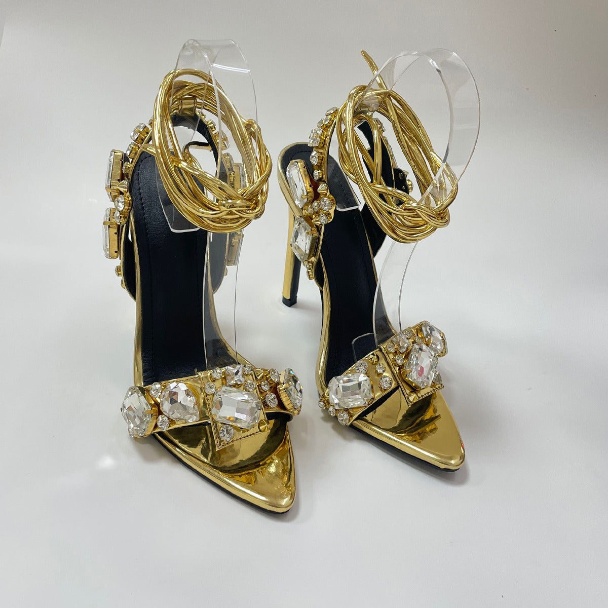 High heeled sandals with cross straps rhinestones exposed toes and a straight line strap